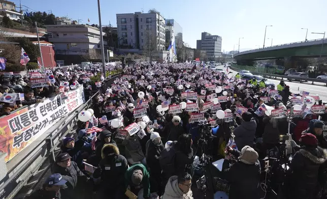 Supporters of impeached South Korean President Yoon Suk Yeol stage a rally near the presidential residence in Seoul, South Korea, Tuesday, Dec. 31, 2024. The letters read "Oppose Impeachment," and "Arrest Lee Jae-myung." (AP Photo/Lee Jin-man)