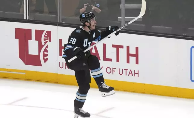 Utah Hockey Club defenseman Mikhail Sergachev (98) reacts after scoring against the Vancouver Canucks during overtime of an NHL hockey game Wednesday, Dec. 18, 2024, in Salt Lake City. (AP Photo/Rick Bowmer)