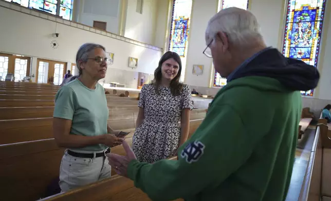 Peggy Stapleton, left, and her daughter Zoey, a current postulant at the Franciscan Sisters, T.O.R. of Penance of the Sorrowful Mother, talk with a fellow parishioner after morning Mass at their home church, St. Joan of Arc Catholic Church, in Hershey, Pa., Wednesday, July 3, 2024. (AP Photo/Jessie Wardarski)