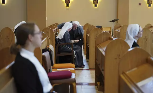 Sisters of the order, Franciscan Sisters, T.O.R. of Penance of the Sorrowful Mother, talk after Mass in Toronto, Ohio, Thursday, Nov. 7, 2024. (AP Photo/Jessie Wardarski)