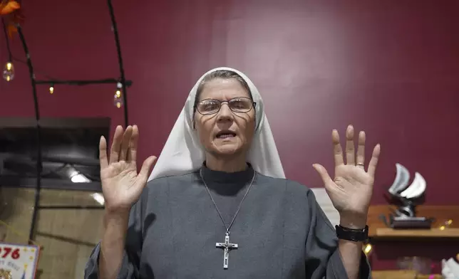 Sister Joan Paule Portenlanger of the Franciscan Sisters, T.O.R. of Penance of the Sorrowful Mother, worship at Urban Thrift and Opportunity Center, in Steubenville, Ohio, Thursday, Nov. 7, 2024. (AP Photo/Jessie Wardarski)