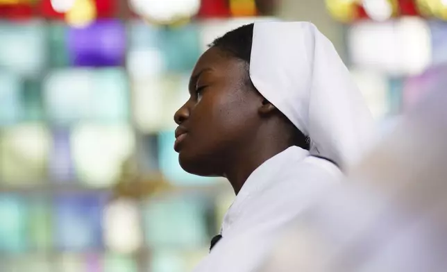 Sister Seyram Mary Adzokpa of the Sisters of the Holy Family prays the rosary in the chapel of the motherhouse in New Orleans, Tuesday, June 25, 2024. (AP Photo/Jessie Wardarski)