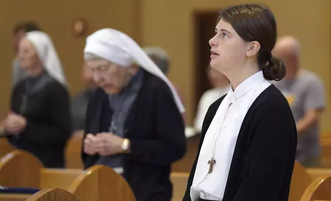 Zoey Stapleton, a postulant with the Franciscan Sisters, T.O.R. of Penance of the Sorrowful Mother, attends Mass in Toronto, Ohio, Thursday, Nov. 7, 2024. (AP Photo/Jessie Wardarski)