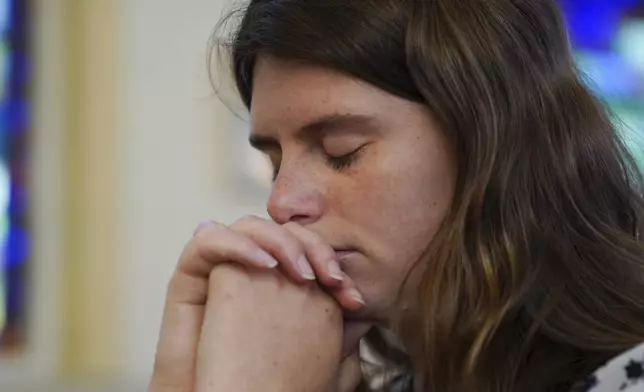 Zoey Stapleton prays during morning Mass at St. Joan of Arc Catholic Church in Hershey, Pa., Wednesday, July 3, 2024. (AP Photo/Jessie Wardarski)