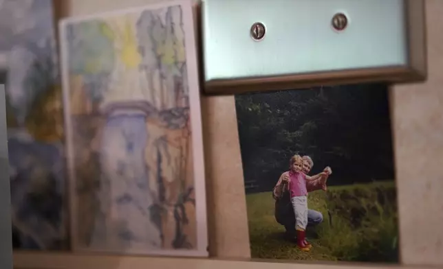 A photo of Zoey Stapleton and her father hangs in the kitchen of their family home, in Palmyra, Pa., Tuesday, July 2, 2024. Stapleton is a current postulant at the Franciscan Sisters, T.O.R. of Penance of the Sorrowful Mother. (AP Photo/Jessie Wardarski)