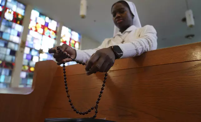 Sister Seyram Mary Adzokpa prays the rosary in the chapel at the motherhouse of the Sisters of the Holy Family in New Orleans, Wednesday, June 26, 2024. (AP Photo/Jessie Wardarski)