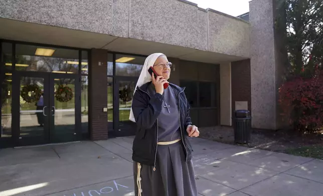 Sister Joan Paule Portenlanger of the Franciscan Sisters, T.O.R. of Penance of the Sorrowful Mother takes a phone call while working as campus ministry at Franciscan University, in Steubenville, Ohio, Thursday, Nov. 7, 2024. (AP Photo/Jessie Wardarski)
