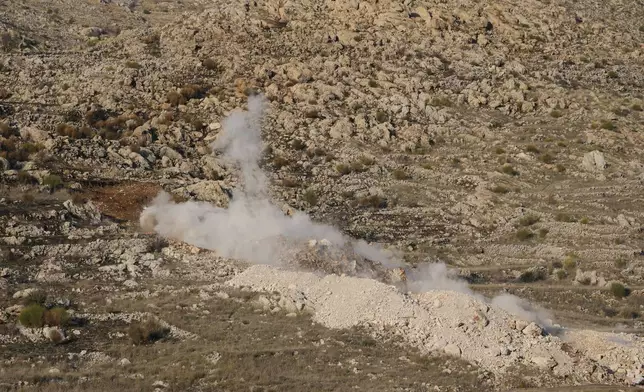 Smoke rises from a controlled explosion inside the buffer zone near the so-called Alpha Line that separates the Israeli-controlled Golan Heights from Syria, in Majdal Shams, Tuesday, Dec. 17, 2024. (AP Photo/Matias Delacroix)