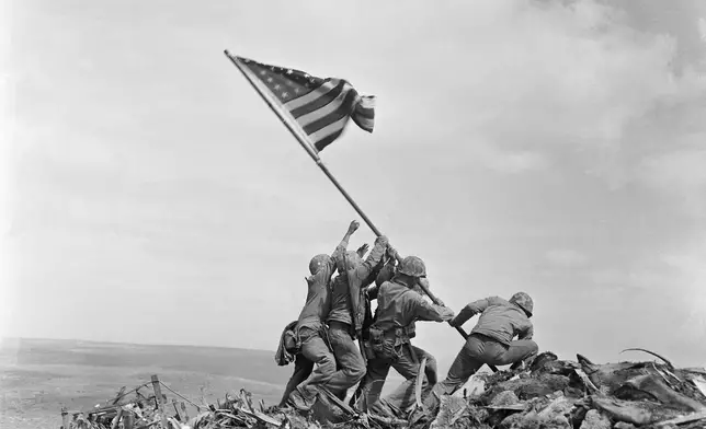 FILE - U.S. Marines of the 28th Regiment, 5th Division, raise a U.S. flag atop Mount Suribachi, Iwo Jima, Japan, Feb. 23, 1945. (AP Photo/Joe Rosenthal, File)