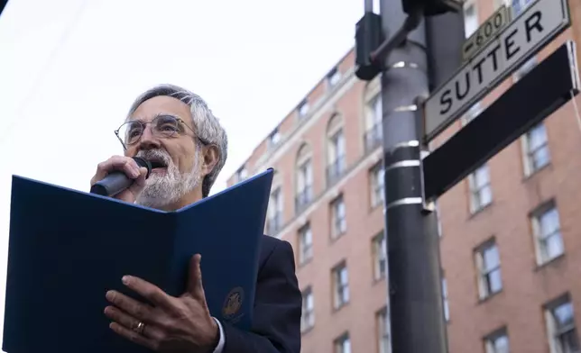 Supervisor Aaron Peskin pays respect during the street renaming to honor former AP photojournalist Joe Rosenthal, who won the Pulitzer Prize for his iconic photo of U.S. Marines raising the flag on the Japanese island of Iwo Jima during WWII, Thursday, Dec. 12, 2024, in San Francisco. (AP Photo/Minh Connors)