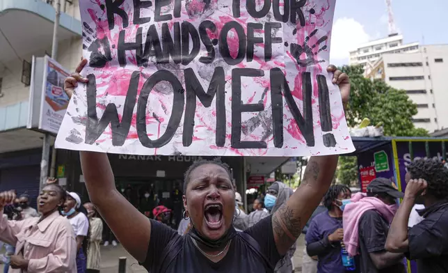 A protester shouts as she holds a placard during a march against the rising cases of femicide, in downtown Nairobi, Kenya, Tuesday, Dec. 10, 2024. (AP Photo/Brian Inganga)