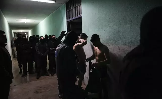 Penitentiary agents search inmates in the pavilions where the most dangerous drug gang members are held at Pinero prison in Rosario, Argentina, Saturday, Sept. 28, 2024. (AP Photo/Rodrigo Abd)