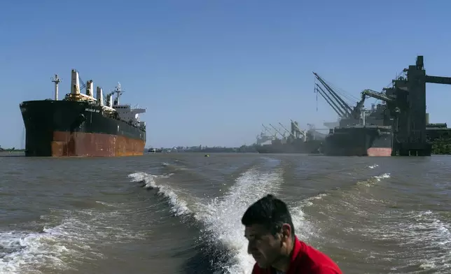 A first responder from a Rosario based company CCREP, patrols the Parana River in a boat in Puerto General San Martin, Argentina, Wednesday, Dec. 4, 2024. (AP Photo/Rodrigo Abd)