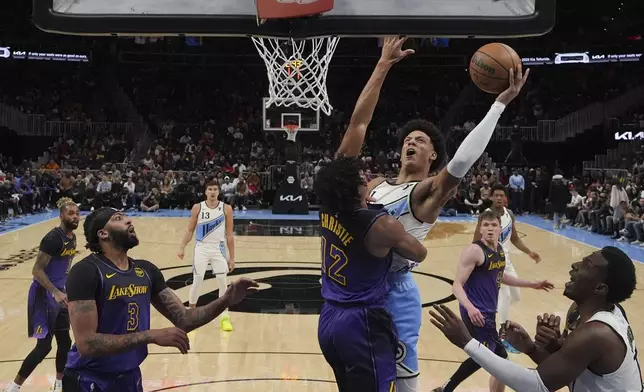 Atlanta Hawks forward Zaccharie Risacher (10) shoots the ball in the first half of an NBA basketball game against the Los Angeles Lakers, Friday, Dec. 6, 2024, in Atlanta. (AP Photo/Brynn Anderson)