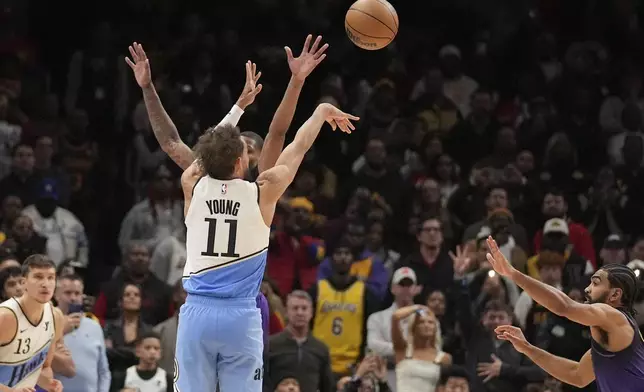 Atlanta Hawks guard Trae Young (11) scores, winning an NBA basketball game against the Los Angeles Lakers, Friday, Dec. 6, 2024, in Atlanta. (AP Photo/Brynn Anderson)