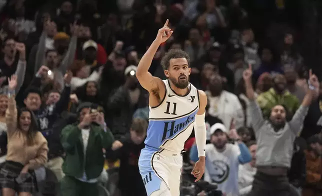 Atlanta Hawks guard Trae Young (11) celebrates after he scores, winning an NBA basketball game against the Los Angeles Lakers, Friday, Dec. 6, 2024, in Atlanta. (AP Photo/Brynn Anderson)