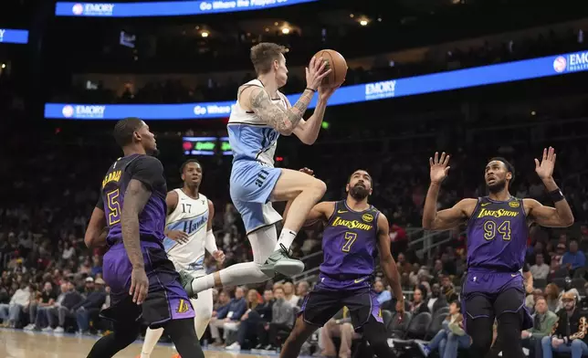 Atlanta Hawks guard Dyson Daniels (5) passes the ball in the first half of an NBA basketball game against the Los Angeles Lakers, Friday, Dec. 6, 2024, in Atlanta. (AP Photo/Brynn Anderson)