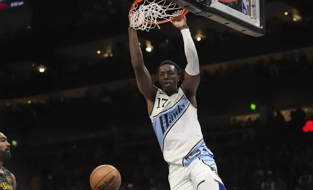 Atlanta Hawks forward Onyeka Okongwu (17) scores in the first half of an NBA basketball game against the Los Angeles Lakers, Friday, Dec. 6, 2024, in Atlanta. (AP Photo/Brynn Anderson)