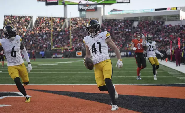 Pittsburgh Steelers linebacker Payton Wilson (41) scores a touchdown after recovering a fumble by Cincinnati Bengals quarterback Joe Burrow during the second half of an NFL football game Sunday, Dec. 1, 2024, in Cincinnati. (AP Photo/Joshua A. Bickel)