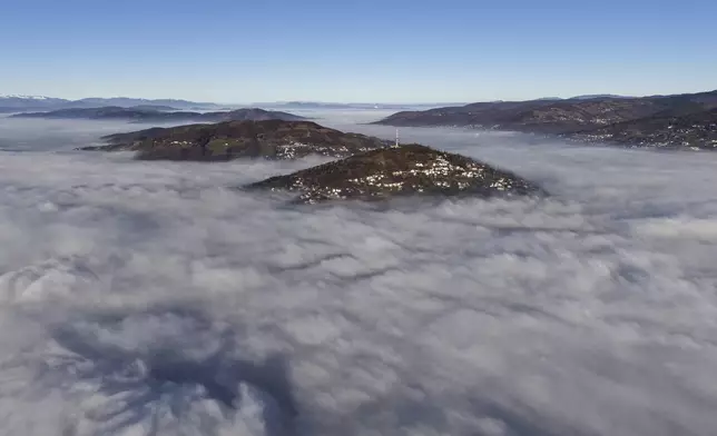 General view of Sarajevo and TV Tower as a dense layer of fog and smog blankets Sarajevo, Bosnia, Thursday, Dec. 19, 2024. (AP Photo/Armin Durgut)