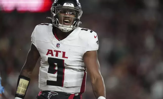 Atlanta Falcons quarterback Michael Penix Jr. (9) celebrates a touchdown during the second half of an NFL football game against the Washington Commanders, Sunday, Dec. 29, 2024, in Landover, Md. (AP Photo/Stephanie Scarbrough)