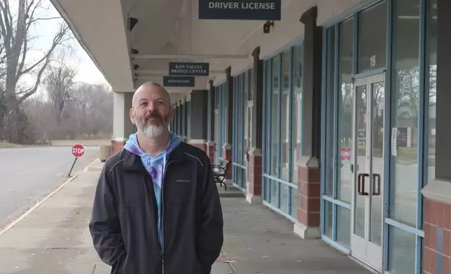 Steven Fish, of Garnett, Kan., stands outside a driver’s license office like one in the same strip mall where in 2014 he went to register to vote, Monday, Dec. 9, 2024, in Lawrence, Kan. Fish was unable to register in 2014 because he didn’t have an acceptable copy of his birth certificate to comply with a proof-of-citizenship law that was later struck down by the federal courts. (AP Photo/John Hanna)