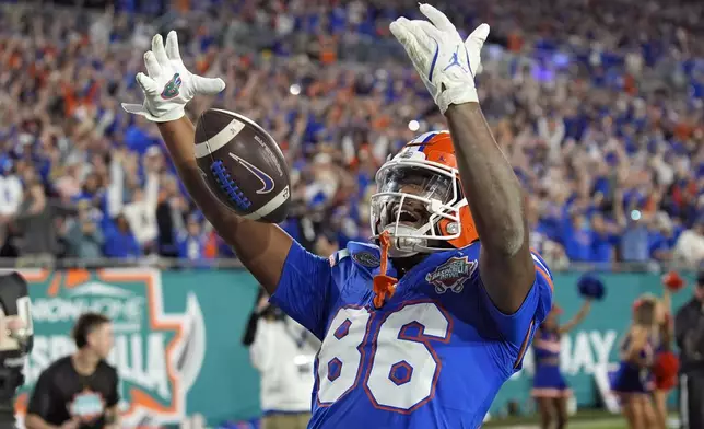 Florida tight end Tony Livingston celebrates after his touchdown during the second half of the Gasparilla Bowl NCAA college football game against Tulane Friday, Dec. 20, 2024, in Tampa, Fla. (AP Photo/Chris O'Meara)