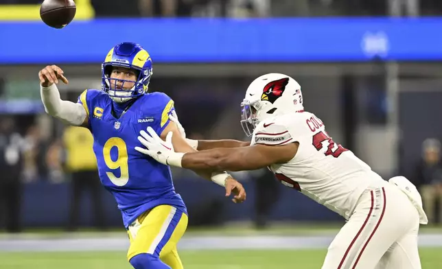 Los Angeles Rams quarterback Matthew Stafford (9) throws under pressure from Arizona Cardinals linebacker Zaven Collins (25) during the first half of an NFL football game Saturday, Dec. 28, 2024, in Inglewood, Calif. (AP Photo/Alex Gallardo)