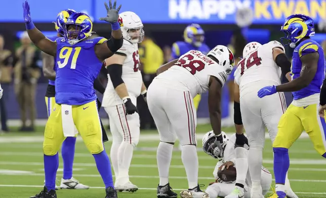 Los Angeles Rams defensive tackle Kobie Turner (91) celebrates after sacking Arizona Cardinals quarterback Kyler Murray during the second half of an NFL football game Saturday, Dec. 28, 2024, in Inglewood, Calif. (AP Photo/Ryan Sun)