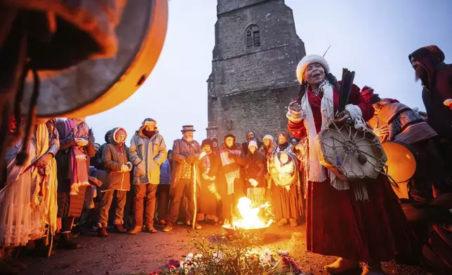 People take part in the winter solstice celebrations during sunrise at Glastonbury Tor in Somerset, England, Saturday Dec. 21, 2024. (James Manning/PA via AP)