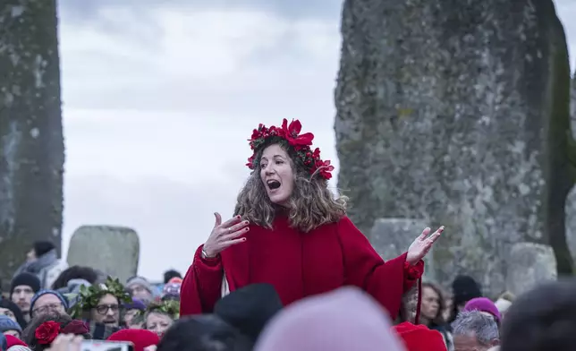 People take part in the winter Solstice celebrations at Stonehenge, England, Saturday, Dec. 21, 2024. (AP Photo/Anthony Upton)