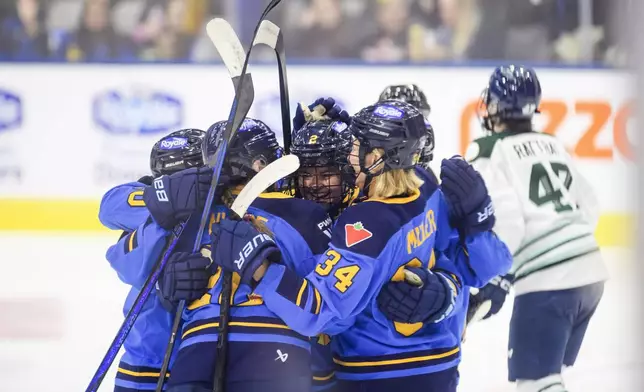 Toronto Sceptres' Jessica Kondas (2), celebrates with teammates after scoring against the Boston Fleet during second period PWHL hockey action in Toronto on Friday, Dec. 27, 2024. (Christopher Katsarov/The Canadian Press via AP)