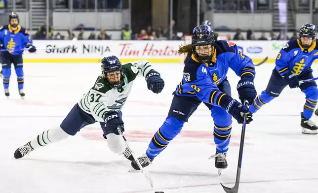 Toronto Sceptres' Jessica Kondas (2) races for the puck with Boston Fleet's Theresa Schafzahl (37) during the first period of a PWHL hockey game in Toronto on Friday, Dec. 27, 2024. (Christopher Katsarov/The Canadian Press via AP)