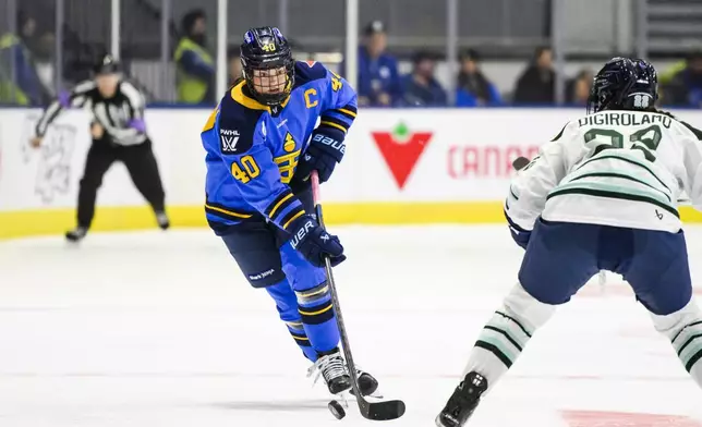 Toronto Sceptres' Blayre Turnbull (40) protects the puck from Boston Fleet's Jessica DiGirolamo (22) during the second period of a PWHL hockey game in Toronto on Friday, Dec. 27, 2024. (Christopher Katsarov/The Canadian Press via AP)