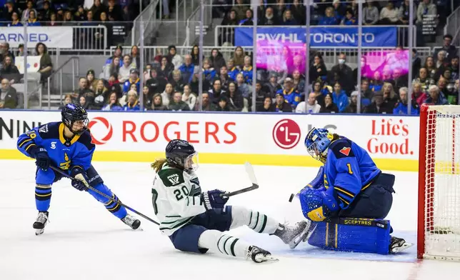 Toronto Sceptres goaltender Raygan Kirk (1) makes a save against Boston Fleet's Hannah Brandt (20) during first-period PWHL hockey game action in Toronto, Friday, Dec. 27, 2024. (Christopher Katsarov/The Canadian Press via AP)