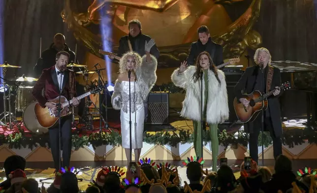 Jimi Westbrook, from left, Kimberly Schlapman, Karen Fairchild and Philip Sweet of Little Big Town participate in the Rockefeller Center Christmas tree lighting ceremony on Wednesday, Dec. 4, 2024, in New York. (Photo by Andy Kropa/Invision/AP)