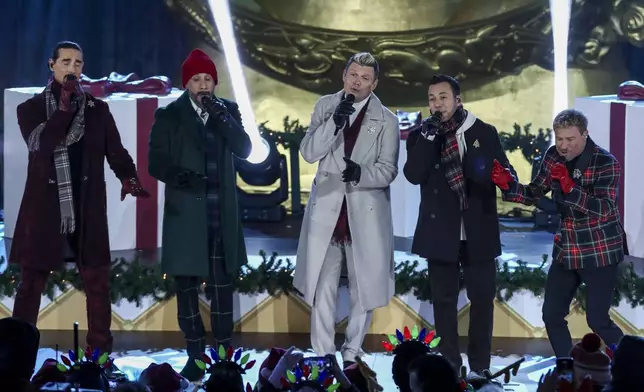 Singers Kevin Richardson, from left, AJ McLean, Nick Carter, Howie Dorough and Brian Littrell of the Backstreet Boys participate in the Rockefeller Center Christmas tree lighting ceremony on Wednesday, Dec. 4, 2024, in New York. (Photo by Andy Kropa/Invision/AP)