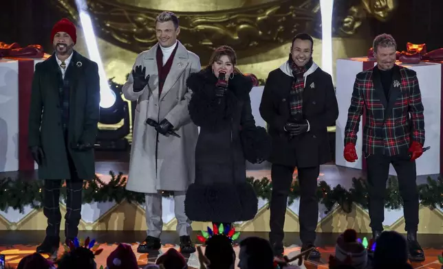 Singers AJ McLean, from left, Nick Carter, Kelly Clarkson, Howie Dorough and Brian Littrell participate in the Rockefeller Center Christmas tree lighting ceremony on Wednesday, Dec. 4, 2024, in New York. (Photo by Andy Kropa/Invision/AP)