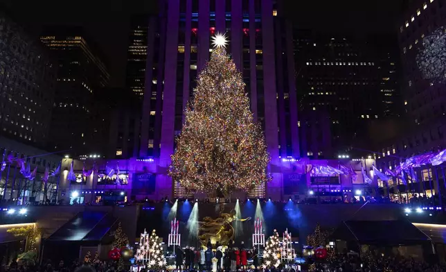 The Rockefeller Center Christmas tree is lit during the 92nd annual Rockefeller Center Christmas tree lighting ceremony, Wednesday, Dec. 4, 2024, in New York. (AP Photo/Julia Demaree Nikhinson)