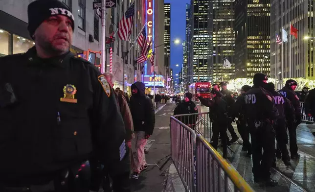 New York police officers keep watch at Rockefeller Center before the start of the Rockefeller Center tree lighting ceremony, Wednesday, Dec. 4, 2024, in New York. (AP Photo/Julia Nikhinson)