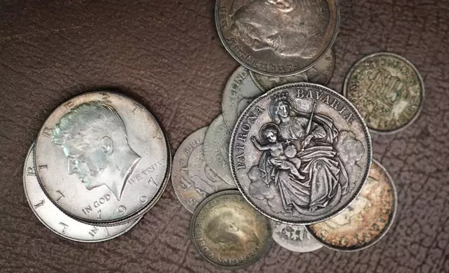 A collection of American and foreign coins await appraisal at Thomaston Place Auction Galleries, Tuesday, Nov. 19, 2024, in Thomaston, Maine. (AP Photo/Robert F. Bukaty)