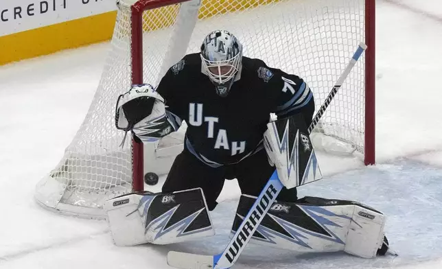 Utah Hockey Club goaltender Karel Vejmelka (70) makes a save against the Minnesota Wild during the first period of an NHL hockey game Tuesday, Dec. 10, 2024, in Salt Lake City. (AP Photo/Rick Bowmer)