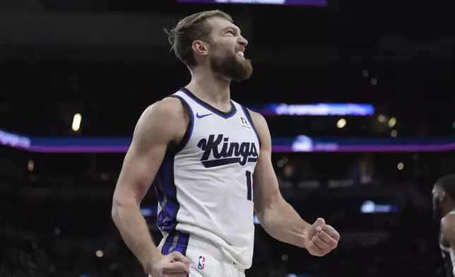 Sacramento Kings forward Domantas Sabonis (11) reacts to a play during the first half of an NBA basketball game against the San Antonio Spurs in San Antonio, Friday, Dec. 6, 2024. (AP Photo/Eric Gay)