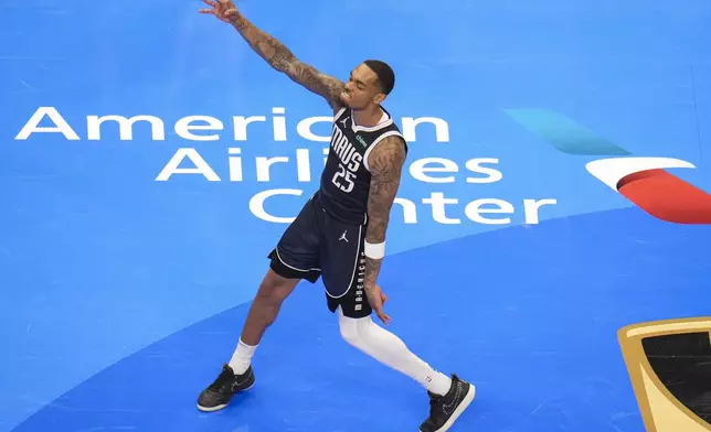 Dallas Mavericks forward P.J. Washington reacts after scoring a basket against the Memphis Grizzlies during the second half of an Emirates NBA Cup basketball game, Tuesday, Dec. 3, 2024, in Dallas. The Mavericks won 121-116. (AP Photo/Julio Cortez)