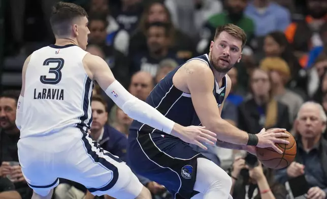 Dallas Mavericks guard Luka Doncic, right, is pressured by Memphis Grizzlies forward Jake LaRavia (3) during the first half of an Emirates NBA Cup basketball game, Tuesday, Dec. 3, 2024, in Dallas. (AP Photo/Julio Cortez)