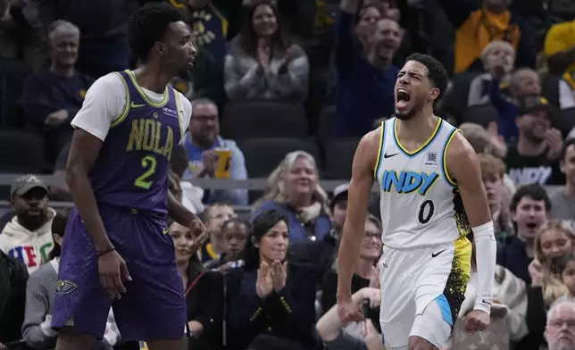 Indiana Pacers' Tyrese Haliburton (0) reacts as New Orleans Pelicans' Herbert Jones (2) walks by during the second half of an NBA basketball game, Sunday, Dec. 15, 2024, in Indianapolis. (AP Photo/Darron Cummings)