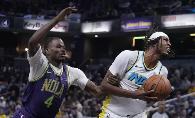 Indiana Pacers' Myles Turner, right, is fouled but New Orleans Pelicans' Javonte Green (4) during the first half of an NBA basketball game, Sunday, Dec. 15, 2024, in Indianapolis. (AP Photo/Darron Cummings)