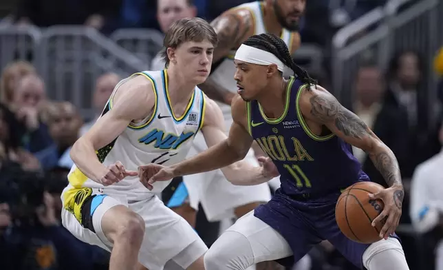 New Orleans Pelicans' Brandon Boston (11) goes to the basket against Indiana Pacers' Johnny Furphy, left, during the first half of an NBA basketball game, Sunday, Dec. 15, 2024, in Indianapolis. (AP Photo/Darron Cummings)