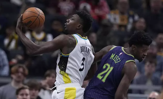 Indiana Pacers' Thomas Bryant (3) grabs a rebound against New Orleans Pelicans' Yves Missi (21) during the first half of an NBA basketball game, Sunday, Dec. 15, 2024, in Indianapolis. (AP Photo/Darron Cummings)