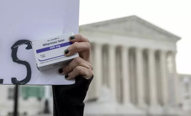 FILE - An abortion- rights activist holds a box of mifepristone pills as demonstrators from both anti-abortion and abortion-rights groups rally outside the Supreme Court in Washington, Tuesday, March 26, 2024. (AP Photo/Amanda Andrade-Rhoades, File)